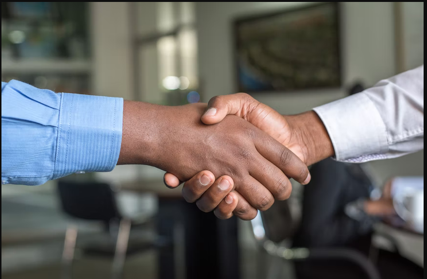 a person handshaking with darren yaw